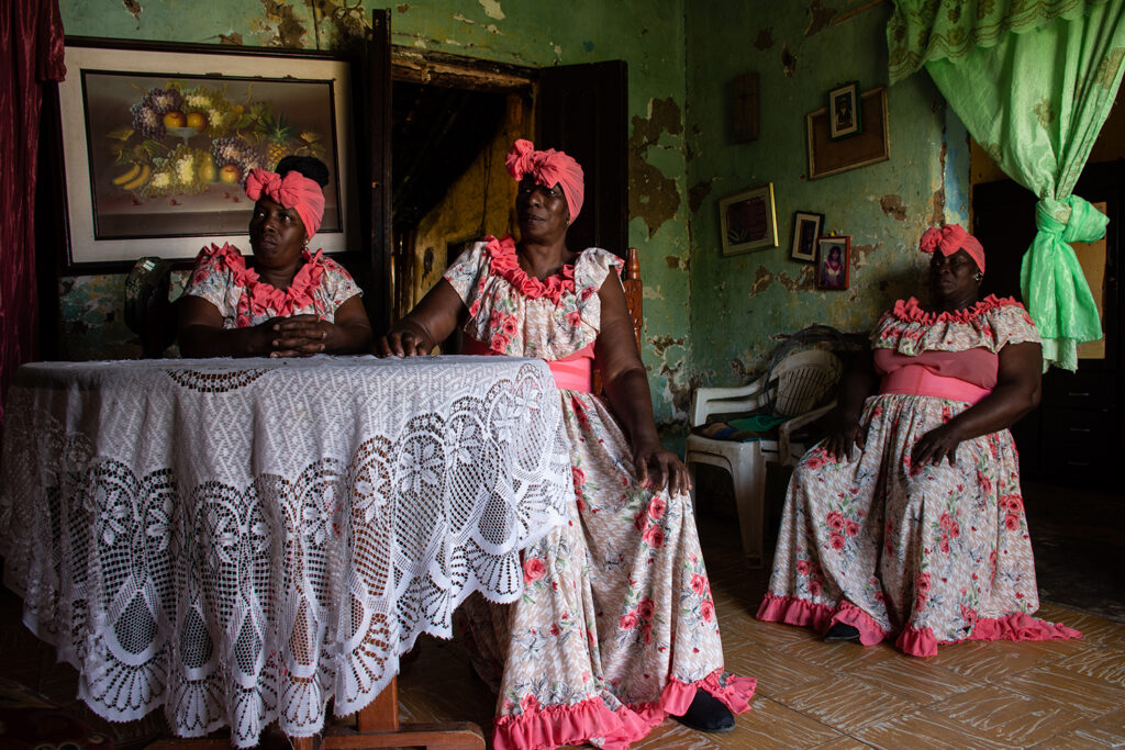 (From left to right) Luz Nelly Balanta, 58, Mirna Rodríguez, 58, and Luciala Balanta Peña, 57, are some of women who lead the realization of Christmas in Quinamayó. In the photo, they wait their turn to participate in a television recording of the celebration.  